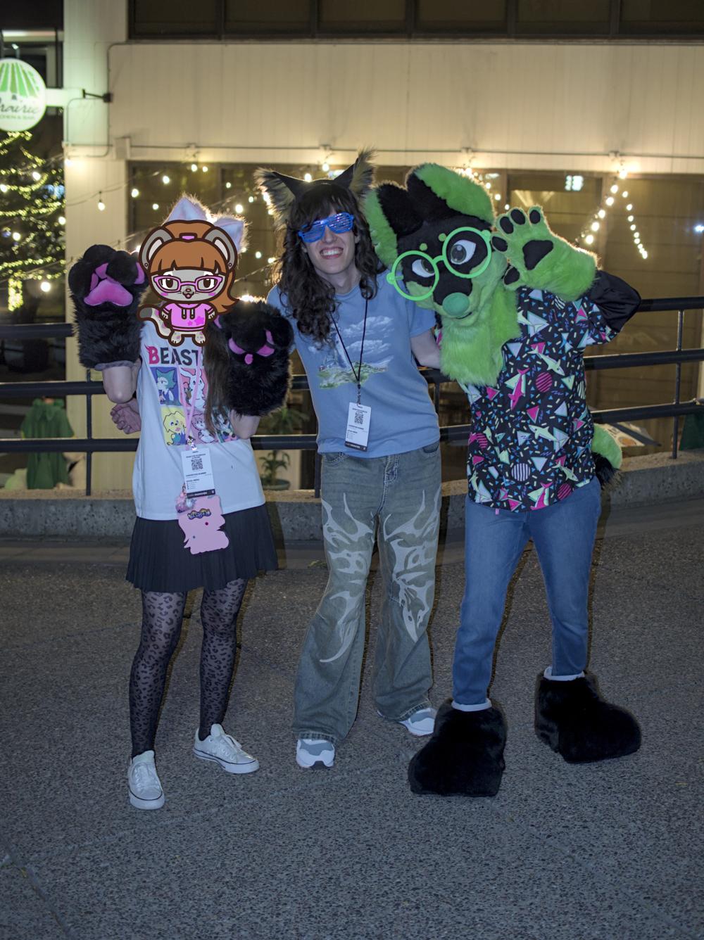 3 people standing together for a photo, the person on the left has their face censored and the person on the right is in a fursuit